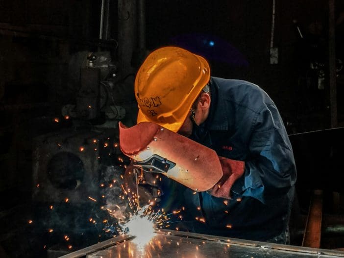 What are Millwrights, Welders, and Riggers? A welder is at work.